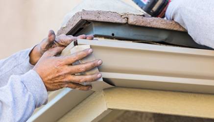 man-repairing-gutter